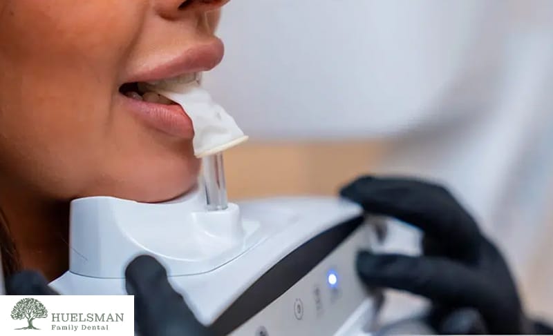 Close-up of a woman’s teeth being examined with dental tools