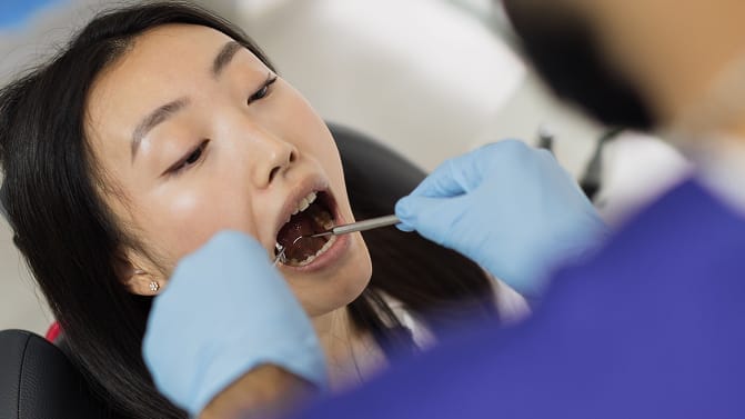 High angle view of female patient, attractive young asian woman sitting in dental chair